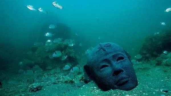 A submerged ancient stone head on the seabed of Alexandria's Eastern Harbor, part of the underwater archaeological remains of Cleopatra's Palace.